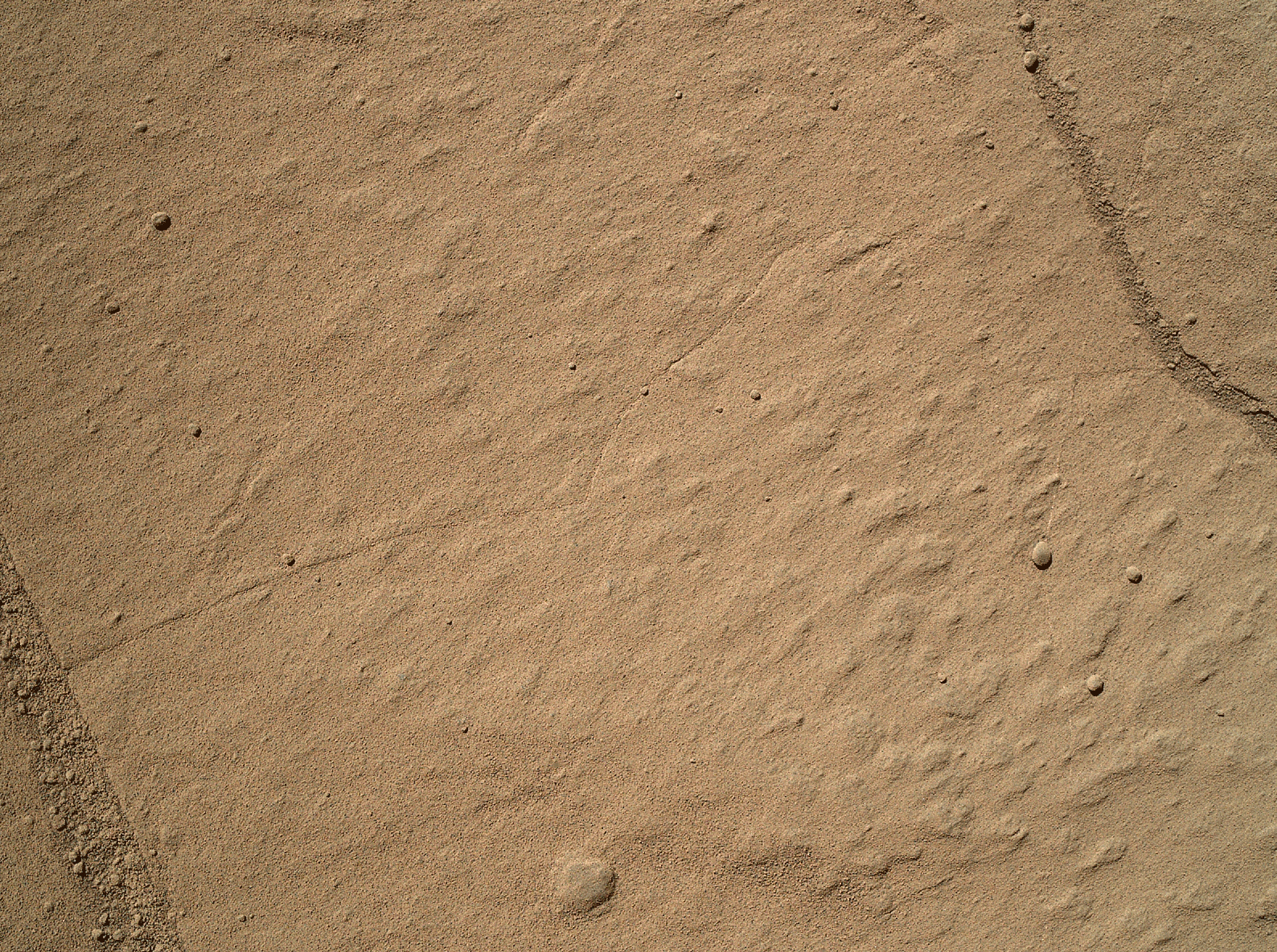 Cette animation montre deux étapes avant et après, d'une petite zone de grès (environ 6 cm de diamètre) frottée avec la brosse anti-poussière du rover Curiosity. Les deux images ont été prises par la caméra Mahli du bras du rover le 612e jour martien, ou SOL, de présence de Curiosity sur Mars, soit le 26 Avril 2014. (source NASA/JPL)